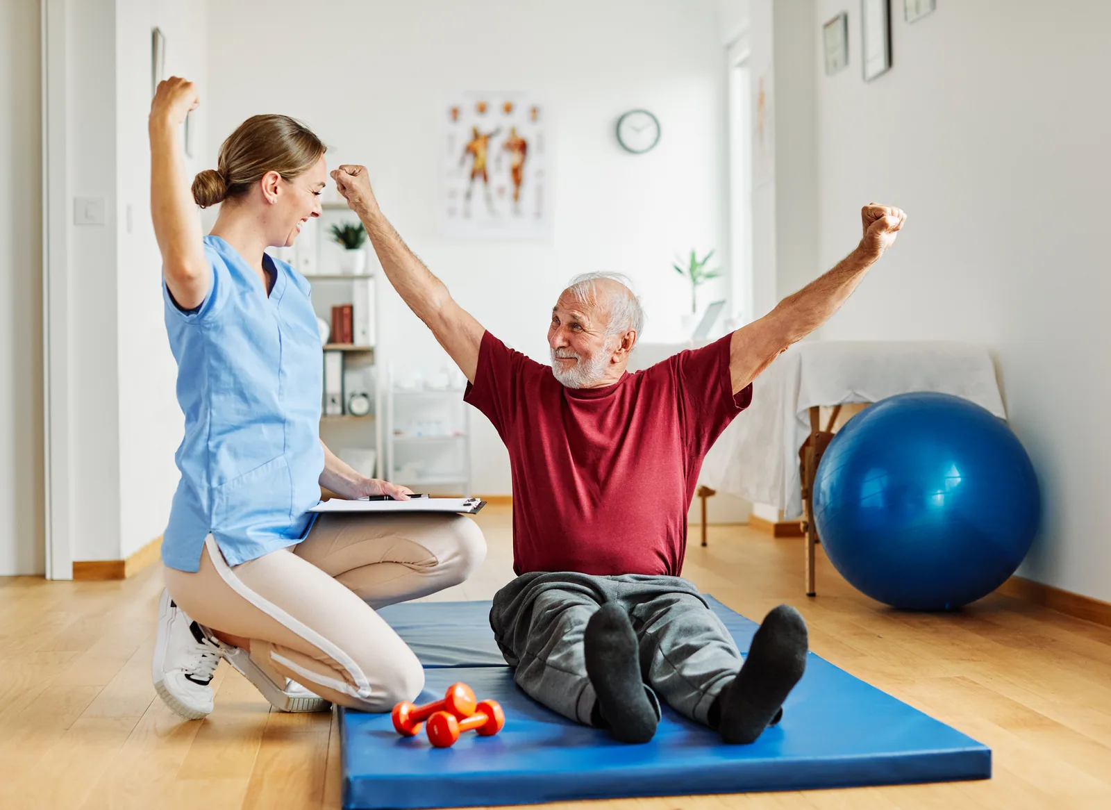 A patient celebrating a milestone with their neuro-rehab therapist