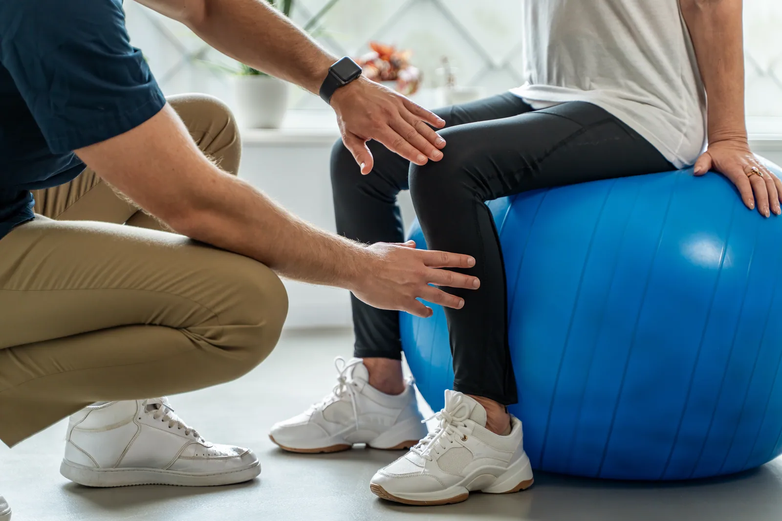 Therapist guiding a patient through an orthopedic rehab exercise