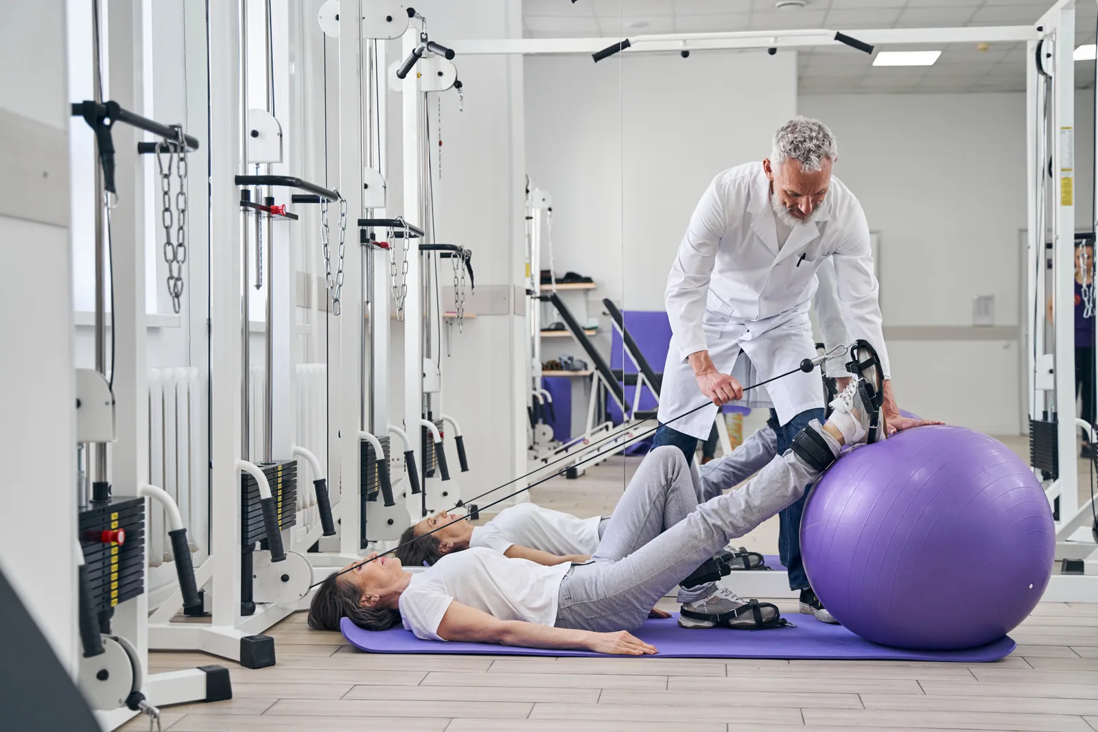 A specialist demonstrating a guided rehab exercise